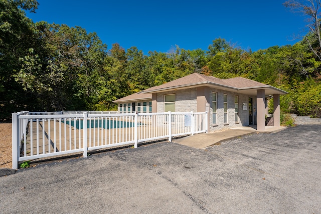 exterior space featuring a fenced in pool and a patio