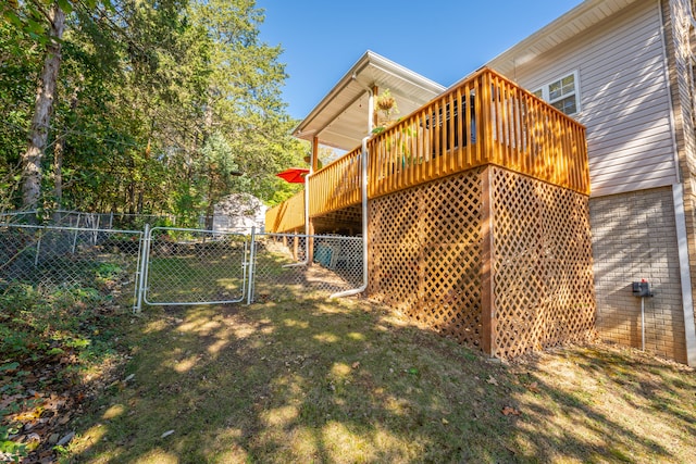 view of yard with a storage unit and a deck