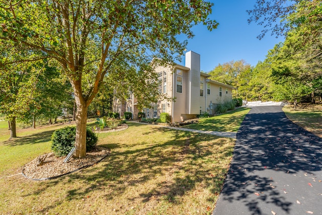 view of property exterior with a lawn