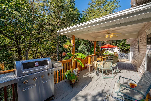 deck featuring area for grilling and ceiling fan