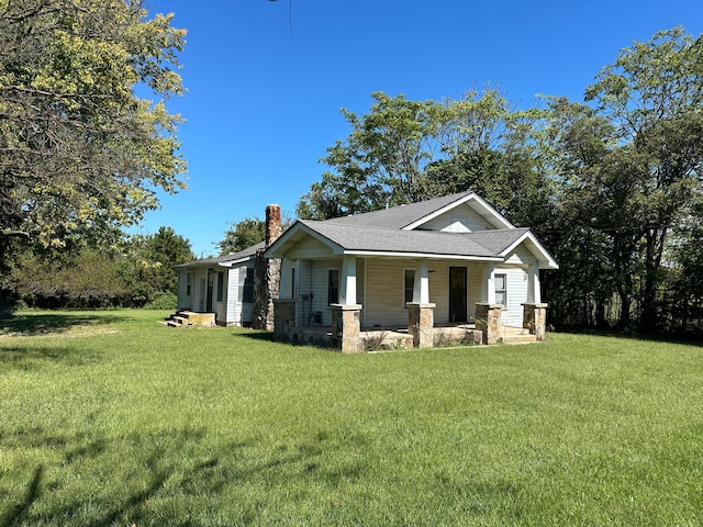 view of front of house with a front yard and covered porch