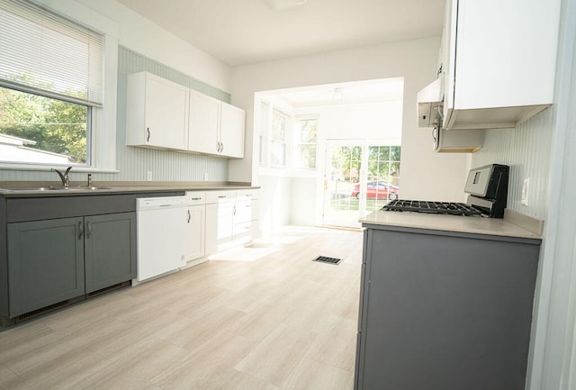 kitchen with white cabinets, stove, sink, dishwasher, and gray cabinets