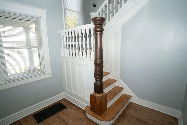 stairway with hardwood / wood-style floors