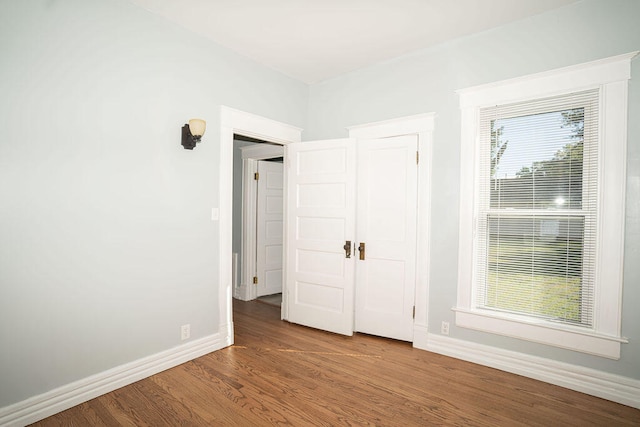 unfurnished bedroom with hardwood / wood-style floors