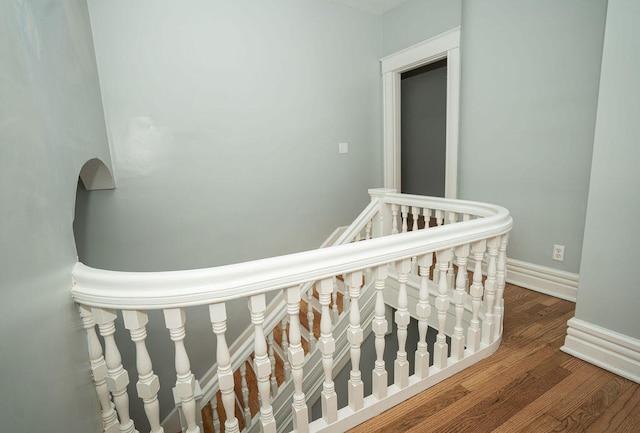 stairway featuring wood-type flooring