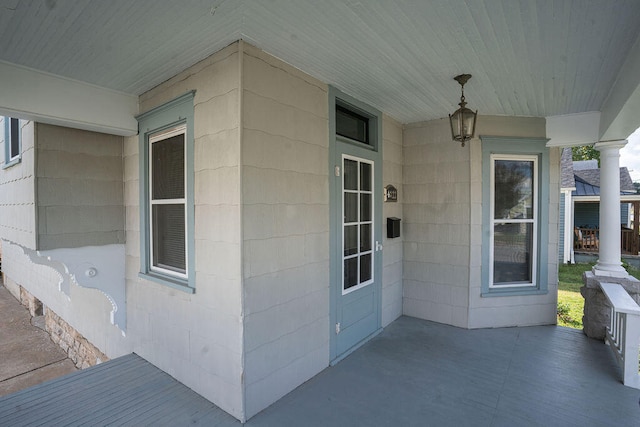 view of exterior entry with covered porch