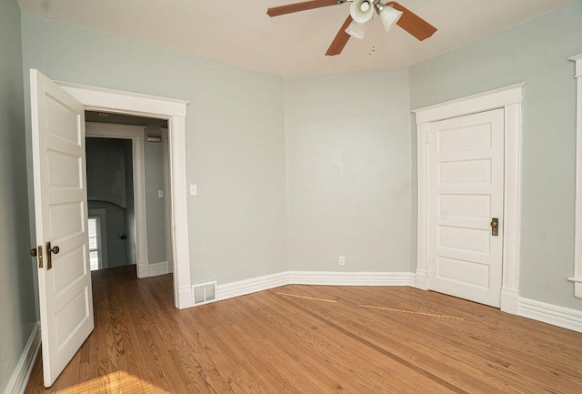 empty room with hardwood / wood-style flooring and ceiling fan