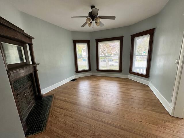 unfurnished living room with ceiling fan and light hardwood / wood-style flooring