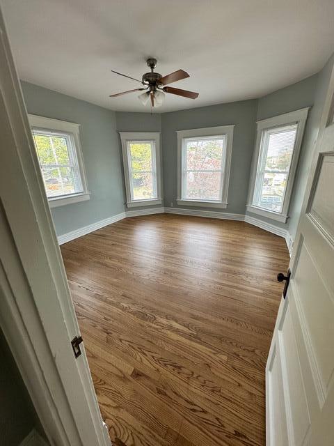 unfurnished room featuring hardwood / wood-style flooring and ceiling fan