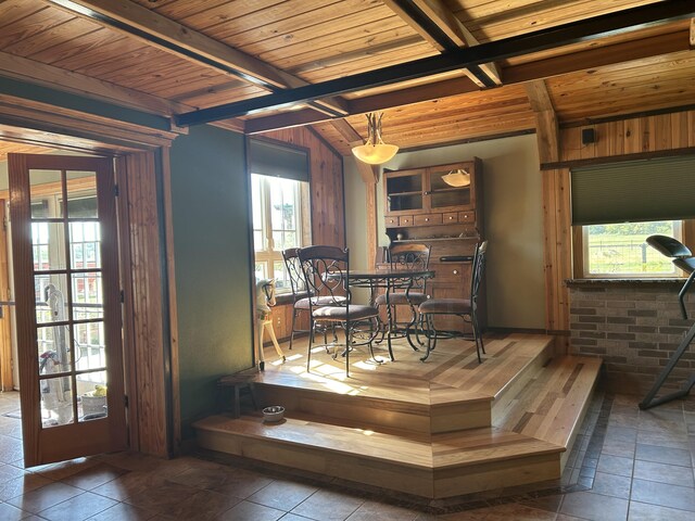 dining area with wood ceiling, beam ceiling, and plenty of natural light