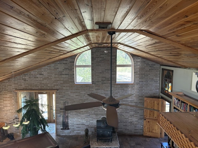 living room with wooden ceiling, a wood stove, brick wall, and lofted ceiling