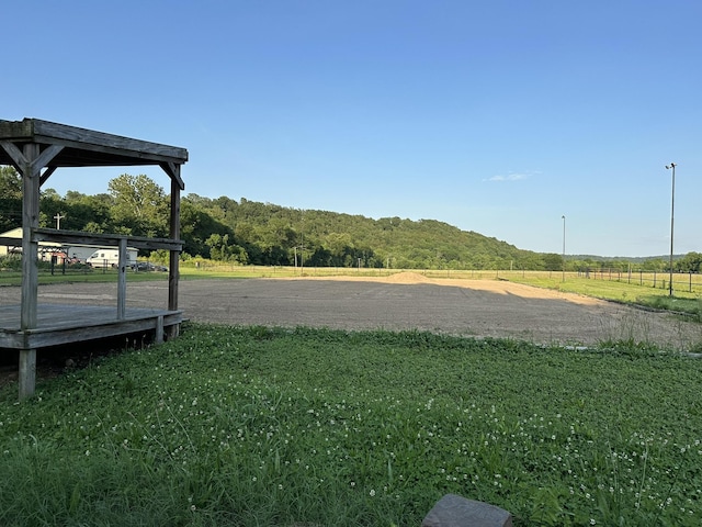 view of yard with a rural view and a deck