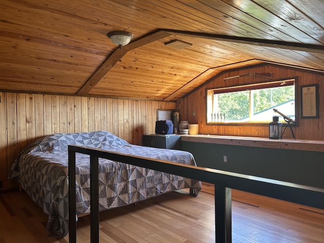 bedroom featuring wood walls, wood finished floors, wooden ceiling, and vaulted ceiling