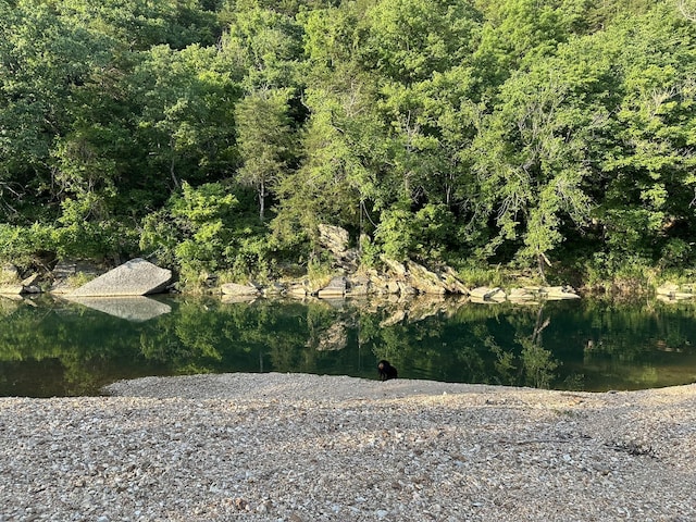 aerial view with a wooded view and a water view
