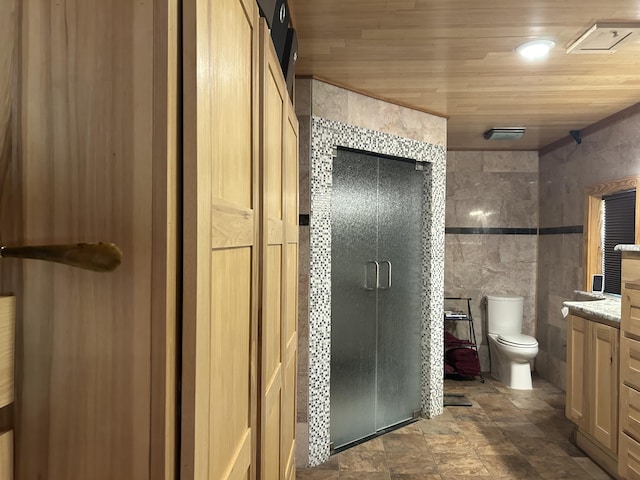 bathroom featuring tile walls, toilet, wood ceiling, a shower stall, and vanity
