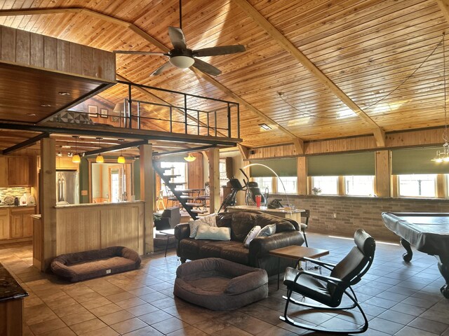 interior space with a ceiling fan, tile patterned flooring, wood ceiling, brick wall, and billiards
