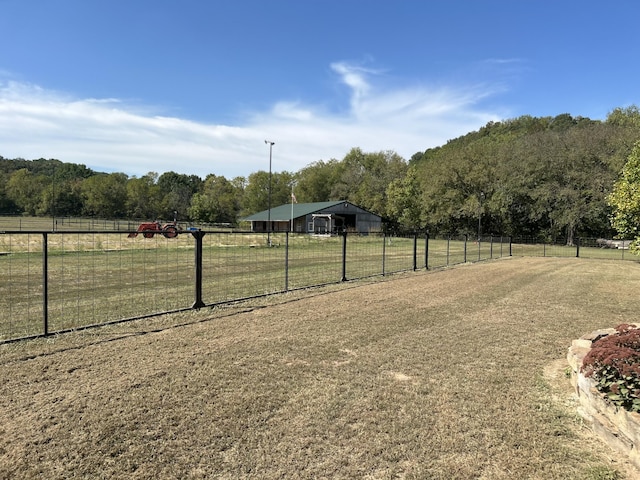 view of yard featuring fence and a rural view