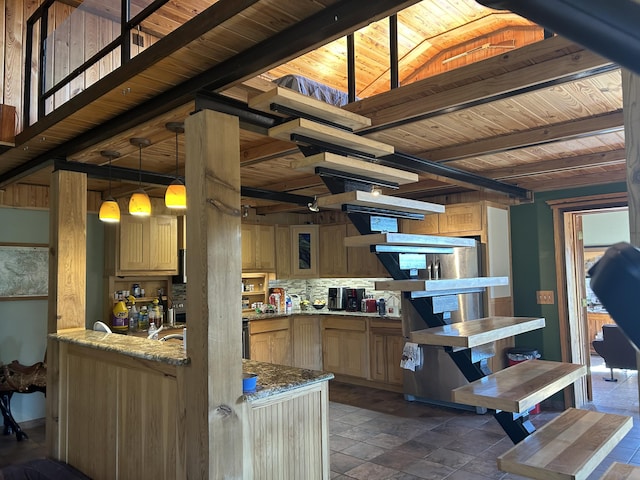 kitchen featuring wooden ceiling, stone tile flooring, beamed ceiling, light stone countertops, and pendant lighting