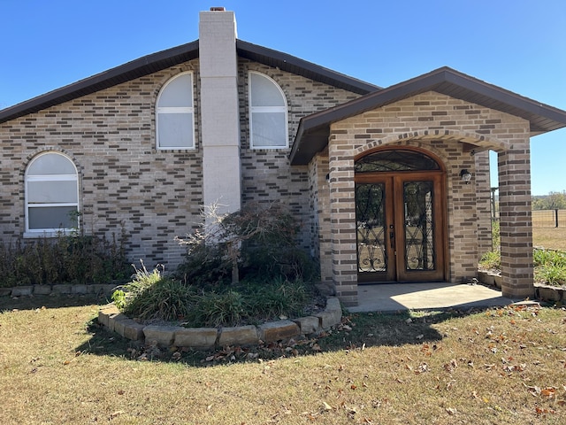 80 State Route Kk, Washburn, MO 65772 - entrance to property featuring brick siding, french doors, a chimney, and a lawn