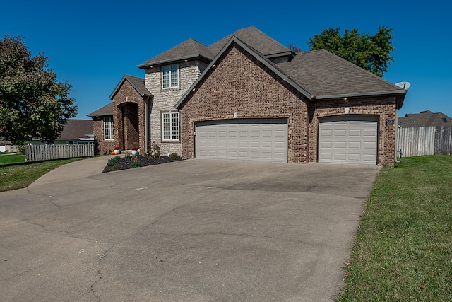 view of front of house featuring a garage and a front lawn