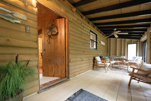 interior space featuring an outdoor hangout area and ceiling fan