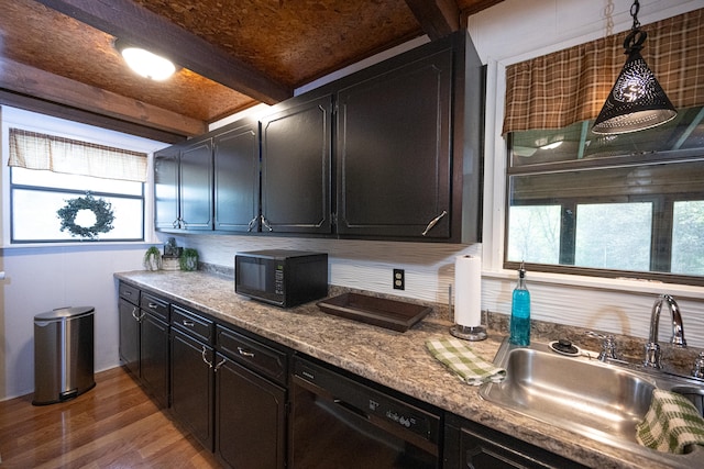 kitchen with black appliances, hardwood / wood-style floors, sink, pendant lighting, and beam ceiling