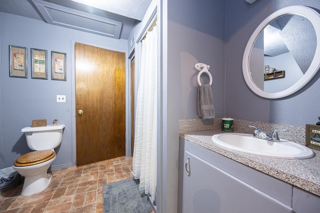 bathroom with walk in shower, vanity, and toilet