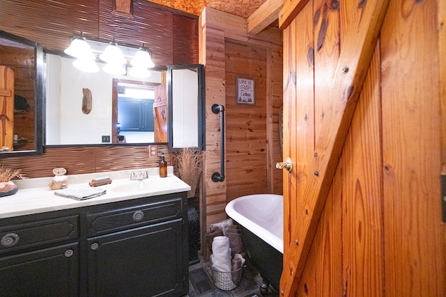 bathroom with wood walls, vanity, and a bathing tub