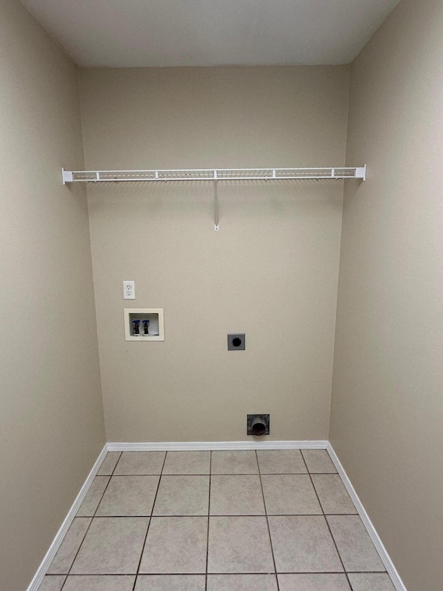 washroom with washer hookup, light tile patterned flooring, and hookup for an electric dryer