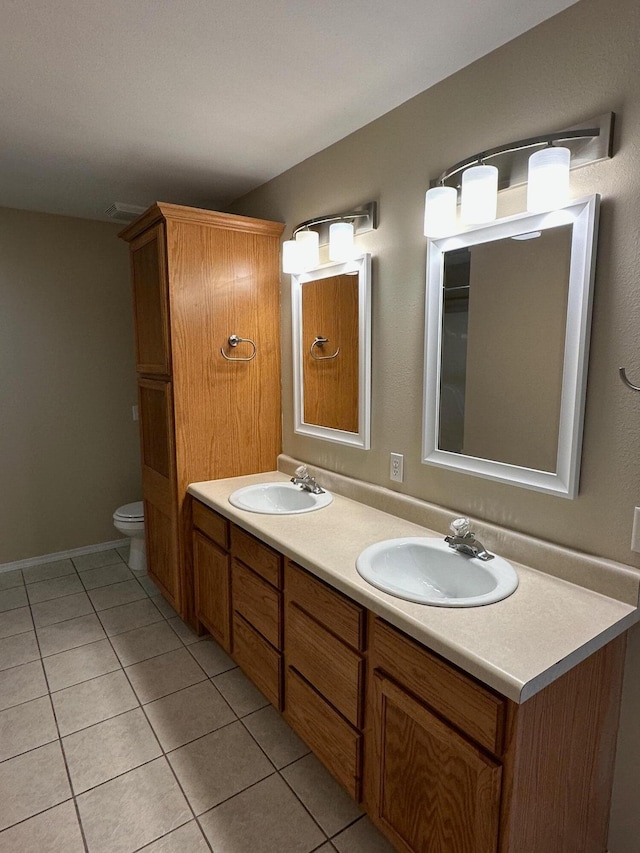 bathroom featuring vanity, tile patterned flooring, and toilet