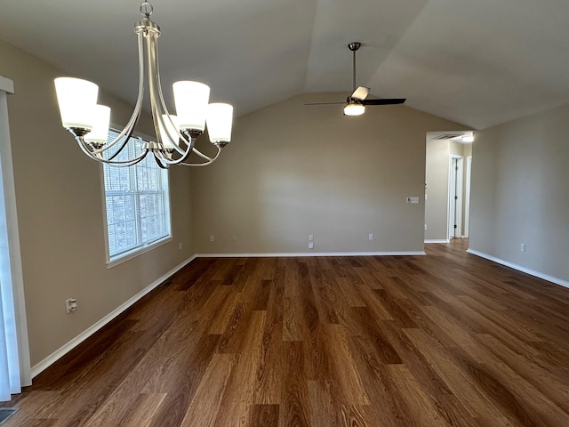 unfurnished dining area with ceiling fan with notable chandelier, vaulted ceiling, and dark hardwood / wood-style flooring