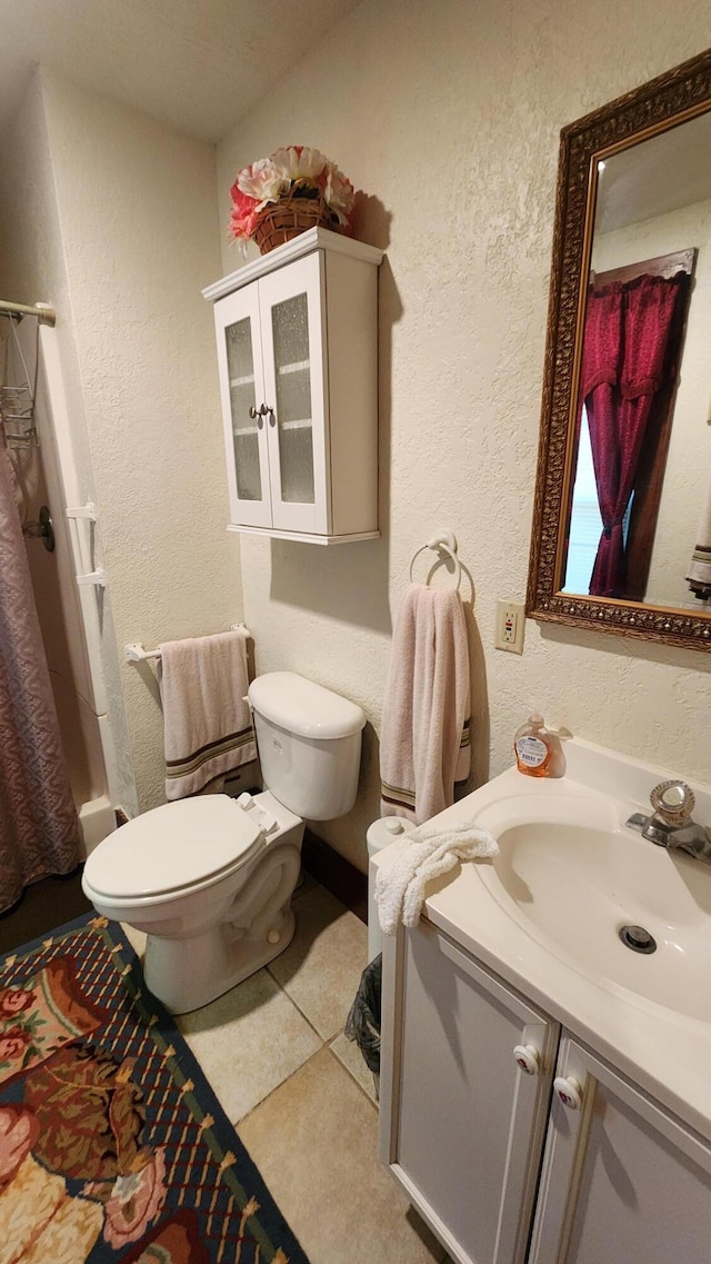 full bathroom with tile patterned floors, shower / bath combination with curtain, vanity, and toilet