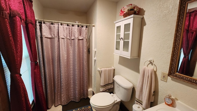 bathroom featuring toilet and shower / bathtub combination with curtain