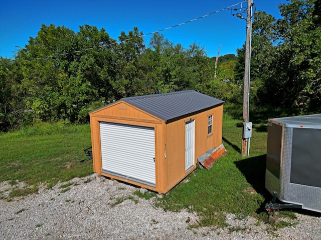 view of outbuilding featuring a lawn