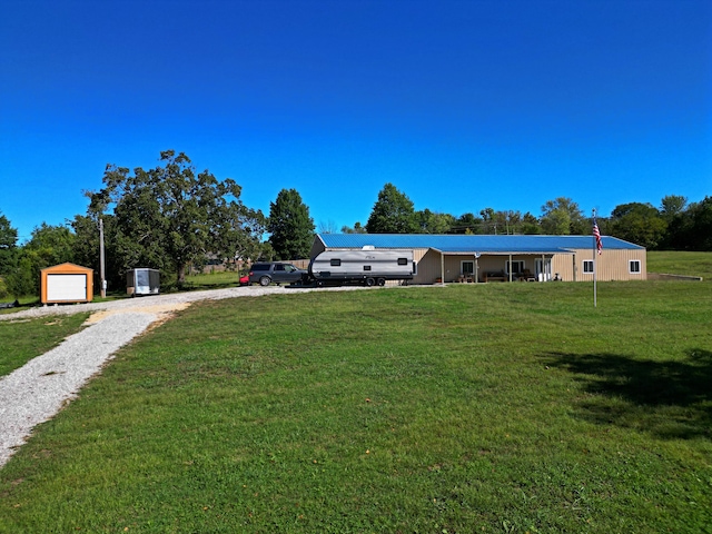 view of yard featuring a garage and an outbuilding