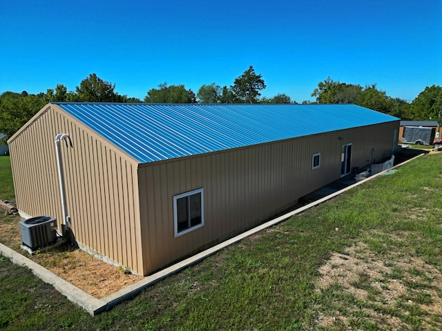 view of home's exterior with central AC unit and a lawn