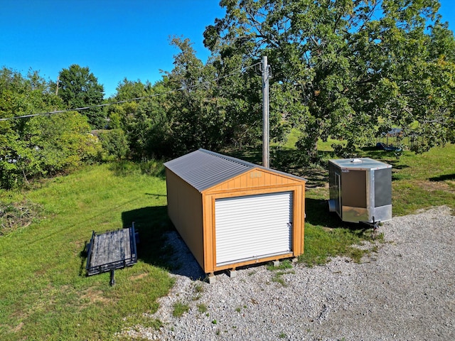 view of outbuilding featuring a yard