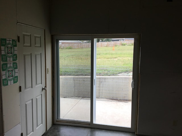 doorway to outside with a wealth of natural light and concrete floors