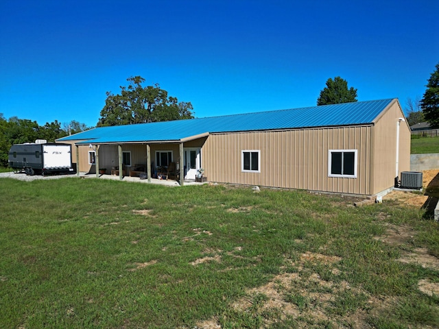 exterior space featuring a garage, a front yard, and central AC unit