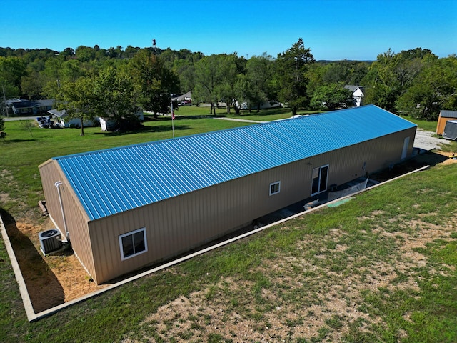 exterior space featuring a yard and central AC unit