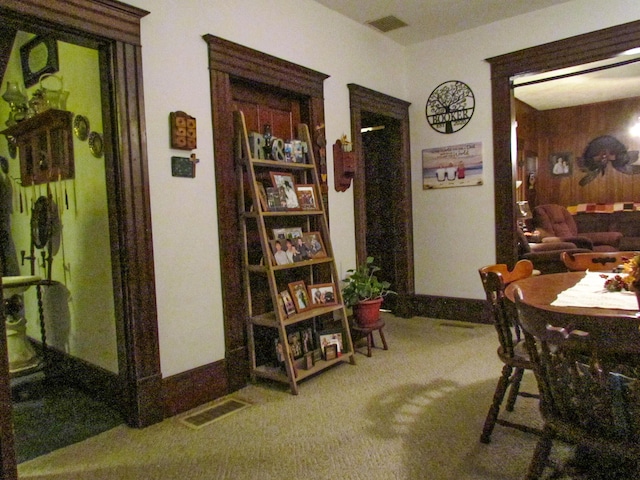 carpeted dining area featuring baseboards and visible vents