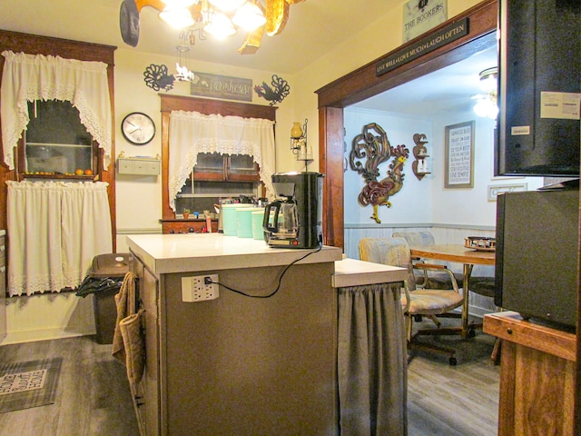 kitchen with dark hardwood / wood-style flooring and a chandelier