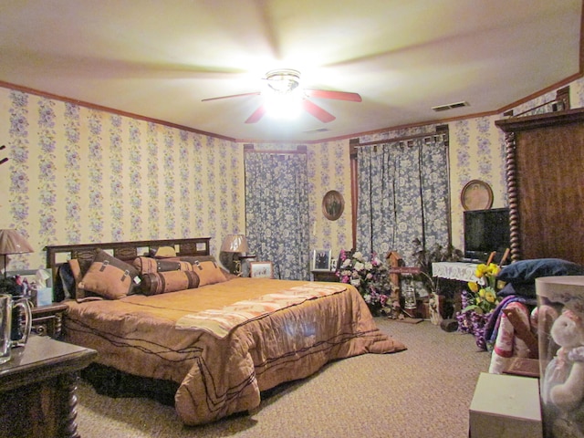 carpeted bedroom with ceiling fan and ornamental molding