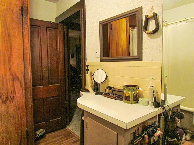 bathroom with wainscoting and tile walls