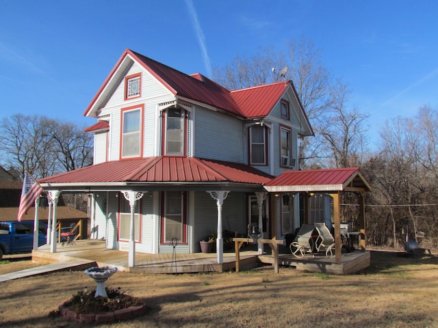 view of front of home with covered porch and a front yard