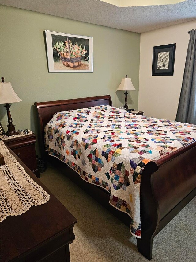 carpeted bedroom with a textured ceiling