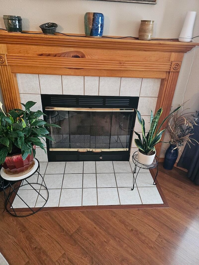 details with a fireplace and wood-type flooring