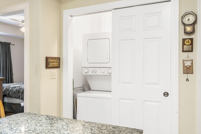 laundry room with stacked washer / drying machine