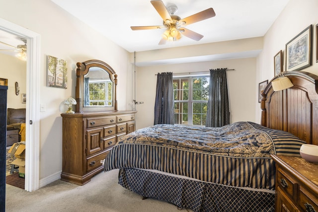 bedroom featuring light colored carpet and ceiling fan