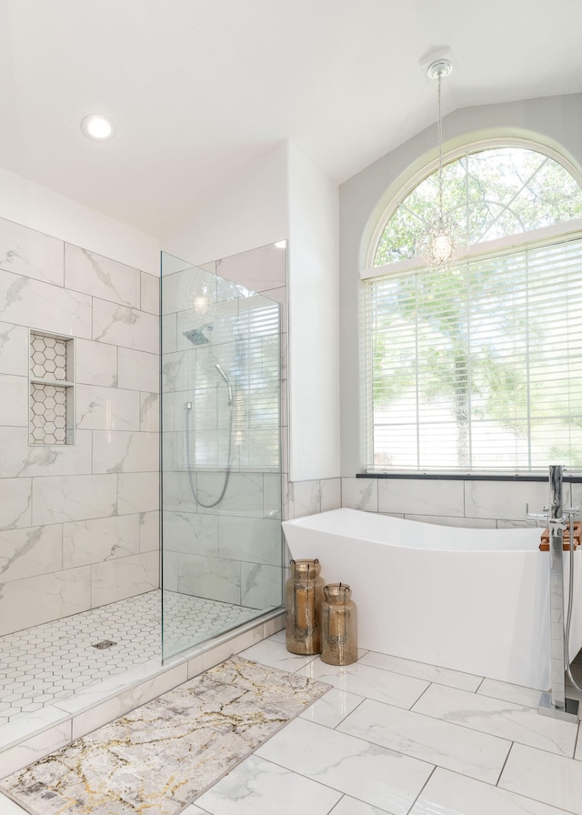 bathroom featuring separate shower and tub